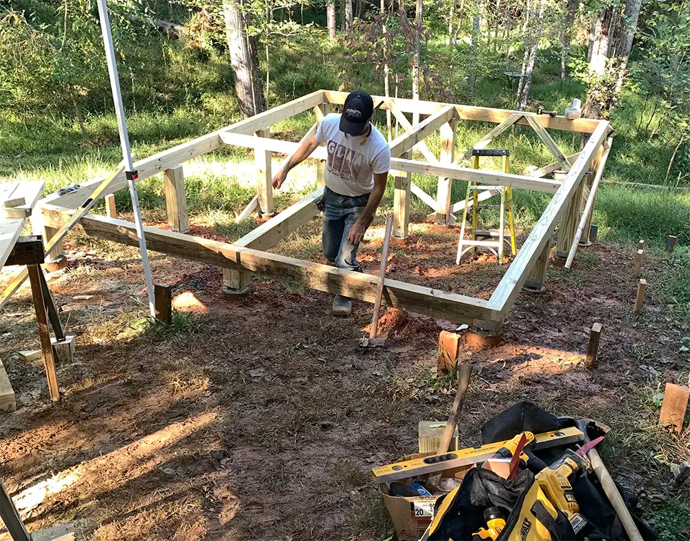 • Mike Huston checking the base frame with his level.